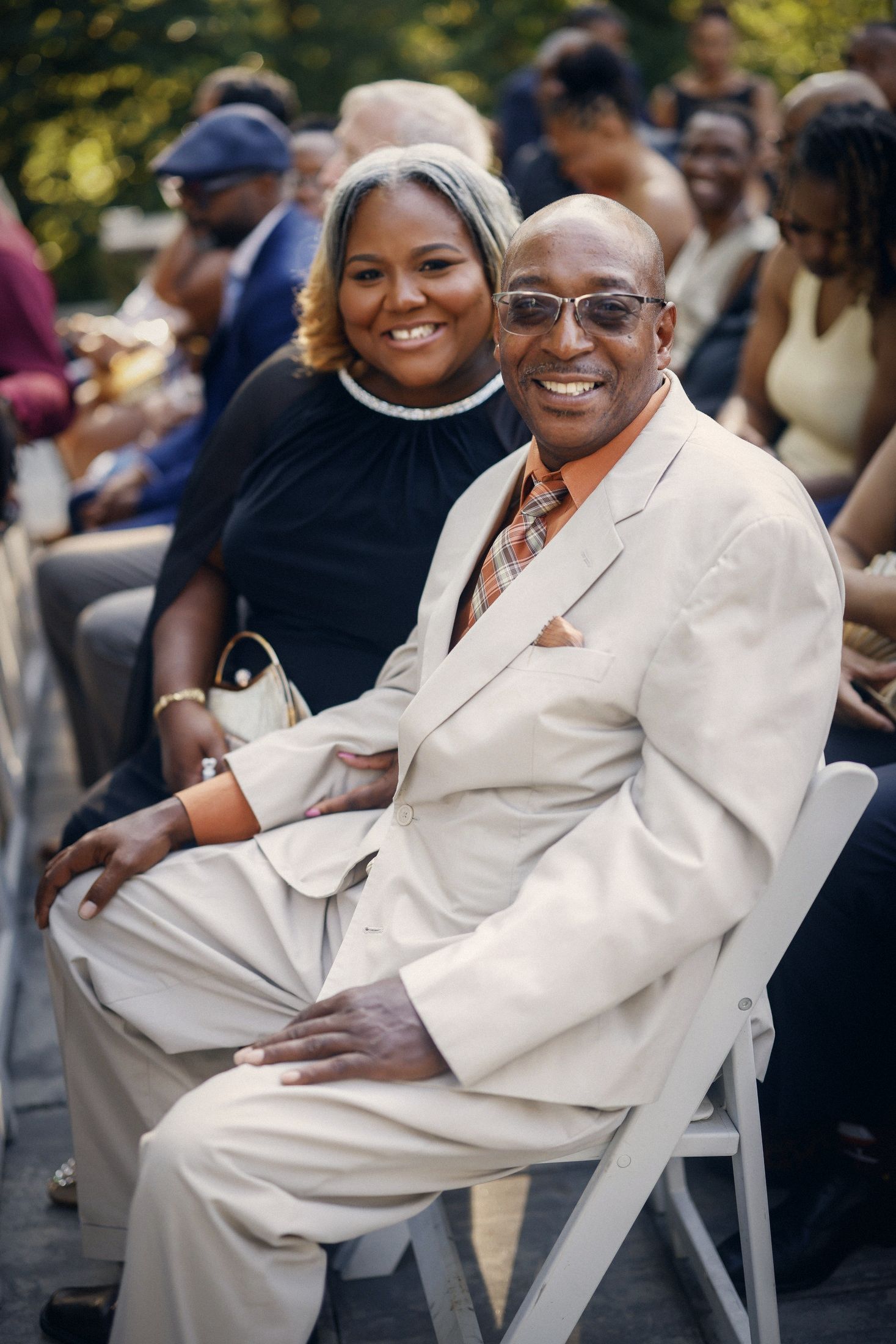 Smiling guests seated at the ceremony